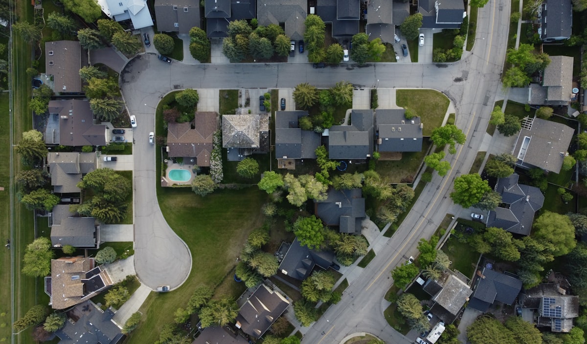 Aerial suburb view with property sales data and market activity